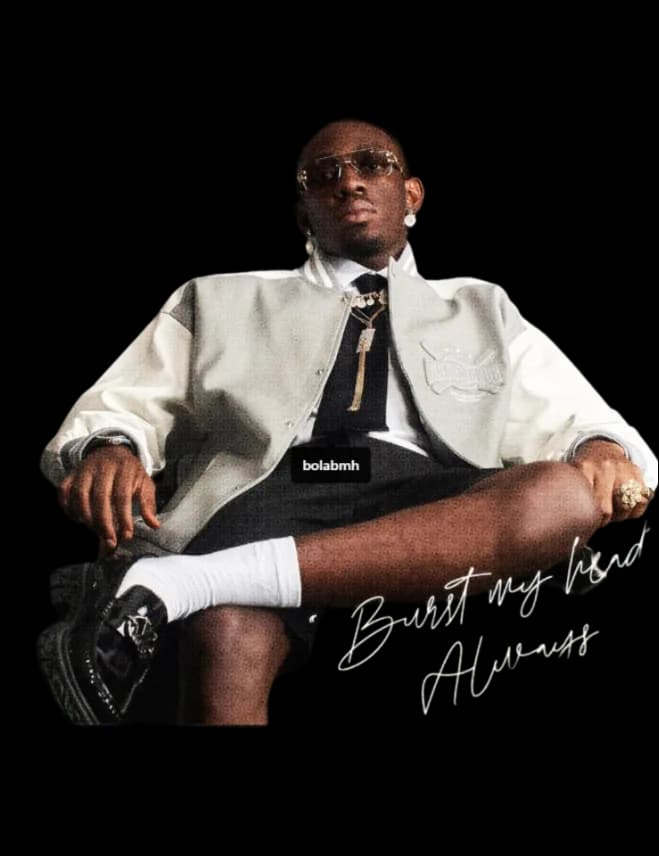 Bola BMH seated in a cream varsity jacket and tie